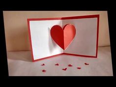 an open card with paper hearts on it