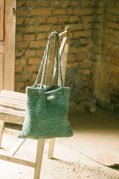 "Sustainable Knitted Bag made of 100% Raw Hemp Uma \"उमा \" : name of a Hindu Goddess \"Parvati\", a mother The word Uma in Sanskrit derives from a name of Hindu Godddess, Parvati who is worshipped as a motherly figure. Ma also means mother in Nepali and Sanskrit.   Uma has been knitted with the same love that a mother gives to her child. The plaited handles alone remind us of the childhood hairstyle our mothers would give us.   The bag has one spacious main compartment and is supported with two Everyday Knitted Straw Tote Bag, Handwoven Yarn Tote Bag, Green Hand Knitted Shoulder Bag For Everyday, Eco-friendly Hand Knitted Rectangular Shoulder Bag, Eco-friendly Crochet Yarn Tote Bag, Everyday Handwoven Yarn Bags, Handwoven Yarn Bags For Everyday Use, Eco-friendly Handwoven Yarn Bag, Eco-friendly Crochet Bag For Everyday Use