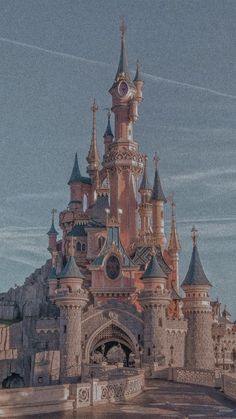 an old castle with towers and clocks on it