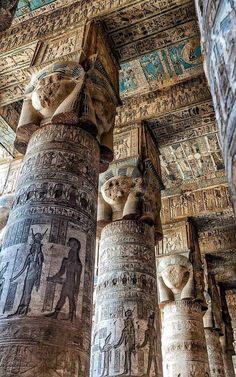 the columns are decorated with ancient egyptian paintings and designs on them, as well as carvings