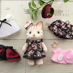 several small stuffed animals and purses on a table