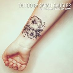 a woman's foot with a flower tattoo on it