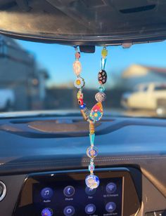 a car dashboard with beads hanging from the dash board