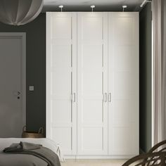 a bedroom with white closets and grey walls