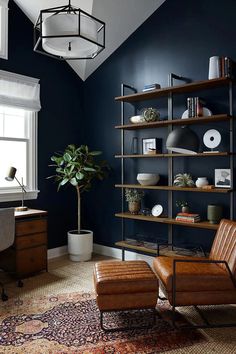 a living room with blue walls and shelves filled with books, vases and other items