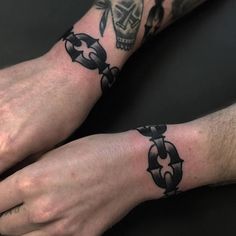 two people with tattoos on their hands