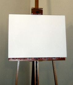 an easel with a white canvas on it