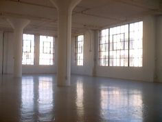 an empty room with large windows and no one in it