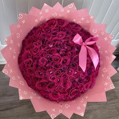 a large bouquet of pink roses in a paper wrapper