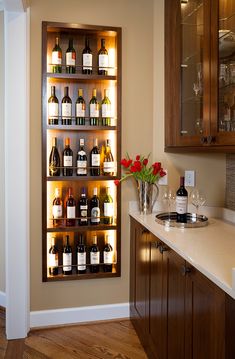 a wine rack filled with lots of bottles on top of a counter next to a sink