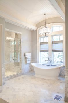 a large bathroom with a tub, toilet and sink