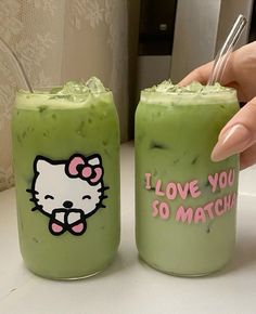 two green drinks with hello kitty stickers on them