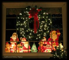 christmas decorations are displayed in front of a window