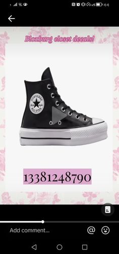 a pair of black converse shoes with pink flowers on the bottom and white soles