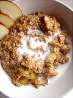 an oatmeal with apples and milk in a bowl