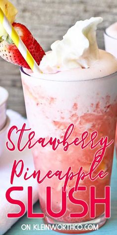 strawberry pineapple slush with whipped cream and strawberries in it on a table