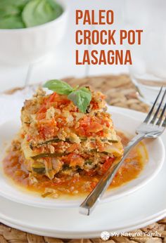 a white plate topped with lasagna covered in sauce