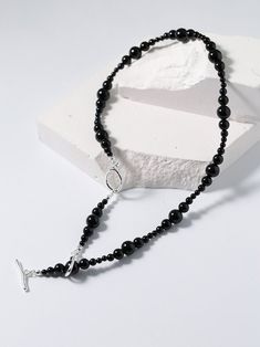 Unique fashion journey with our gradient black onyx chain. Combines sizes of black onyx beads (3mm to 8mm) for a striking and versatile accessory. Features gradient design, clavicle chain fit, and safety buckle for stylish and safe wear. Elevate your style with our black onyx clavicle chain for a sophisticated look. Metal: Recycled Sterling Silver Plated On Brass Gemstone:Black Onyx Necklace length 370-440mm Weight: 21.5g Trendy Black Beaded Necklace Gift, Black Beaded Clavicle Chain Choker, Elegant Black Beaded Necklace With Clavicle Chain, Minimalist Black Beaded Choker Necklace, Elegant Black Beaded Necklaces With Gemstone Beads, Elegant Black Beaded Necklaces With Polished Beads, Trendy Black Beaded Necklaces With Round Beads, Elegant Black Beaded Necklace With Gemstone Beads, Elegant Black Beaded Necklace With Polished Beads