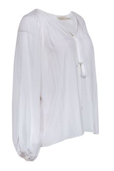 Let Ramy Brook wow you with this all-white peasant top, featuring delicate ties at the neckline and a flattering v-neck cut. With pleating throughout the design, this top is perfect for any occasion - dress it up with a skirt and heels for an elegant evening look, or pair it with jeans and sandals for a casual daytime outfit. Size XS Shell 100% Polyester Unlined Flowy silhouette V neck w/ ties Elasticized cuffs Bust 48” Waist 54” Sleeve length 28” Shoulder to hem 26” White Blouse With Tie Sleeves For Daywear, White Tie Neck Top With Tie Sleeves, White Tie Neck Blouse For Summer, White Tie Sleeves Top For Daywear, White Tops With Tie Sleeves For Daywear, White Tie Neck Top For Summer, Chic White Peasant Top For Daywear, White Blouse With Tie Sleeves For Spring, White Flowy Blouse For Daywear