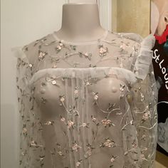 Sheer Blouse With Embroidered Small Pink Flowers. Long Sleeves With Tie At The End. Ruffles Around Top Of Bodice. Small Pink Flowers, Rosé Black And White, White Ruffle Blouse, Rose Cream, Lace Blouse Long Sleeve, Black Sheer Blouse, Ruffle Bell Sleeve, Ladies Blouse, Lace Top Long Sleeve