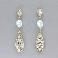 "Start your married bliss wearing our graceful \"Rita\" crystal teardrop earrings. This bridal accessory was designed in a long elegant teardrop style using sweetheart shaped crystals and featuring a silky twisted Swarovski pearl to complement your wedding dress. These delicate sparkling beauties are your forever earrings, bound up in lovely, romantic thoughts. ❣ Earring length is approx. 1.7\". ❣ Available set in rhodium, gold and rose gold. ❣ Highest-quality marquise cubic zircon crystals set Elegant Teardrop Crown Earrings For Wedding, Teardrop Crystal Pearl Drop Earrings, Elegant Teardrop Chandelier Earrings For Anniversary, Pearl Drop Earrings For Brides, Wedding Crystal Earrings With Pearl Drop, White Crystal Teardrop Earrings For Wedding, Wedding Crystal Earrings With Sparkling Pear-shaped Stones, Pearl Drop Teardrop Crystal Earrings, White Teardrop Drop Earrings For Wedding