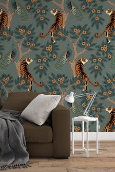 a living room with a couch and wallpaper that has a tiger pattern on it