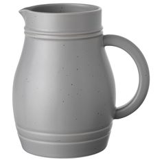 a gray ceramic pitcher is shown on a white background, with small speckles