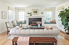 a living room filled with furniture and a fire place next to a wooden coffee table