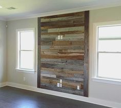 an empty room with wood paneling and windows