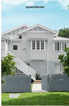 an image of a grey house with white trim on the front and stairs leading up to it