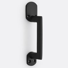 a black door handle on a white wall