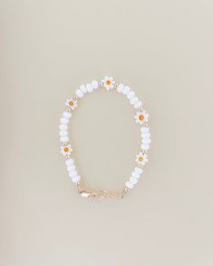 Dainty White Hypoallergenic Bracelets, Dainty Hypoallergenic White Bracelets, Dainty White Hypoallergenic Bracelet, White Dainty Flower Shaped Beaded Bracelets, White Dainty Beaded Bracelet With Flower Charm, Dainty White Beaded Bracelet With Flower Charm, White Flower-shaped Bracelet With Tiny Beads, Adjustable White Pearl Bracelet In 14k Gold Filled, White Daisy Bracelets As Gift