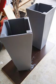 two square vases sitting on top of a table