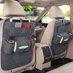 the interior of a car with two cups in it and one cup holder on the back seat