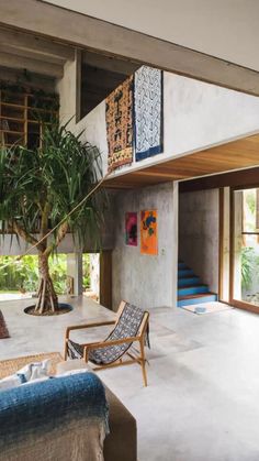 a living room filled with furniture and a tree