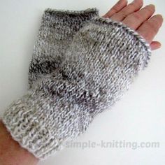 a hand that is holding some kind of knitted mitten in it's palm