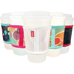 six cups with different designs on them are lined up