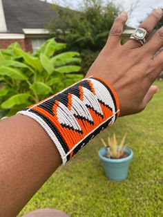 Handmade with snap buttons closure Handmade White Cuff Bracelet, Handmade Adjustable Orange Cuff Bracelet, Handmade Orange Adjustable Cuff Bracelet, Handmade Orange Cuff Bracelet Bangle, Handmade Orange Cuff Bangle, Adjustable White Artisan Cuff Bracelet, Handmade Orange Bangle Cuff Bracelet, Adjustable Orange Cuff Bracelet, Unique Adjustable Cuff Beaded Bracelets