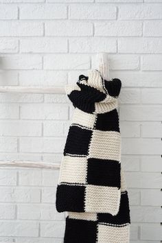 "A perfect blends of comfort and elegance, this over sized white and black checkerboard scarf is truly statement piece for your winter wardrobe, stay warm in style with our hand knit chunky wool scarf,  you can also use it as a shawl to wrap for a chilly day out or a cozy evening at home. It's designed to complement any outfit.   - Crafted with care, this scarf is a labor of love, with over 12 hours of meticulous needlework, stitch by stitch, to create a truly one-of-a-kind piece - Made from 100% premium wool, it's a testament to our commitment to quality and warmth - Approximate dimensions: 72\" in length and 8.5'' in width  - Care Instructions: hand wash only, and lay it flat to dry to ensure its longevity *Please note that all our items are handmade, which means each one is a work of ar Chunky Wool Scarf, Handmade Wool Scarf, Sustainable Knitwear, Black And White Scarf, Women Scarves, Modern Knitting, Cozy Evening, Hand Knit Scarf, Chunky Wool