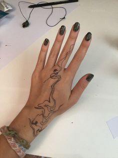 a woman's hand with a tattoo on it