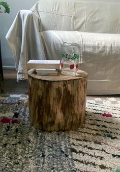 a wooden table sitting on top of a rug next to a couch