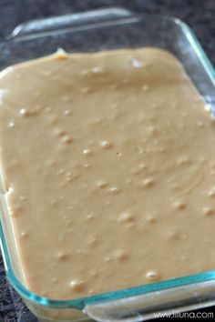 a glass dish filled with batter sitting on top of a counter