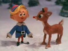 an image of a cartoon character talking to another figure in the snow with christmas trees behind them