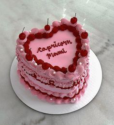 a heart - shaped cake with the words captain mama written on it is sitting on a plate