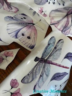 three plates with dragonflies and flowers on them