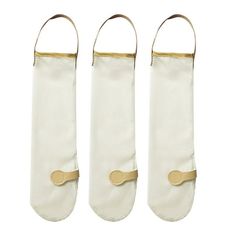 three white stockings with gold trims and handles on each side, one is empty