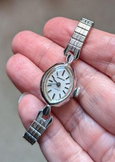 This is a beautiful Benrus white gold ladies watch that is currently working! I am not a watch expert, nor have I had it tested or serviced, it is being sold AS IS. I've wound it several times and it keeps fairly good time, not perfect, but ok.  I would strongly recommend having it serviced by a professional. The marquis shaped face has a pearly white face and silver hands and numerals. The watch screams MCM! This watch  would best fit a wrist 5.5" or smaller. The band is a stretch so easy, comfy fit! The watch is 10k RGP. Given the age of the watches there will be scuffs and scratches, I do my best to highlight them in the pics and detail them in the description so there are no unpleasant surprises after purchase! This one is really lovely!! This bracelet makes a statement and are perfect Whimsigoth Wedding, Stretch Band, Stretch Bands, White Face, Steampunk Fashion, Jewelry Cleaner, Ladies Watch, Not Perfect, Comfy Fits