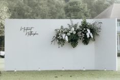 flowers are placed on the side of a white wall