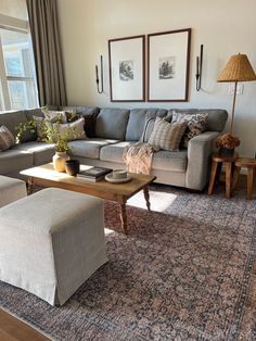 a living room filled with furniture and pillows on top of a carpeted floor next to a window