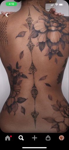 the back of a woman's body with flowers on it